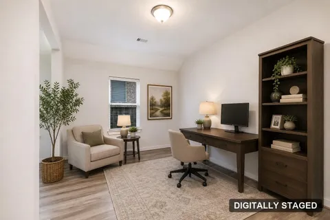 The same flex room shown staged as a home office (digitally staged)