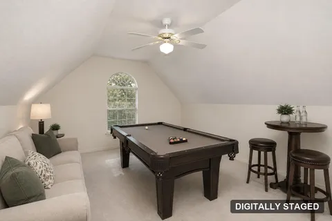 Upstairs gameroom shown staged with a pool table (digitally staged)