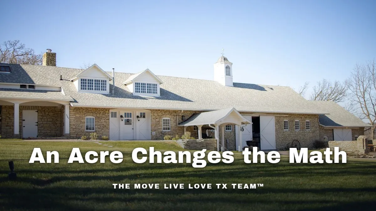 A one-acre custom home lot with mature trees and a long driveway in bright afternoon light