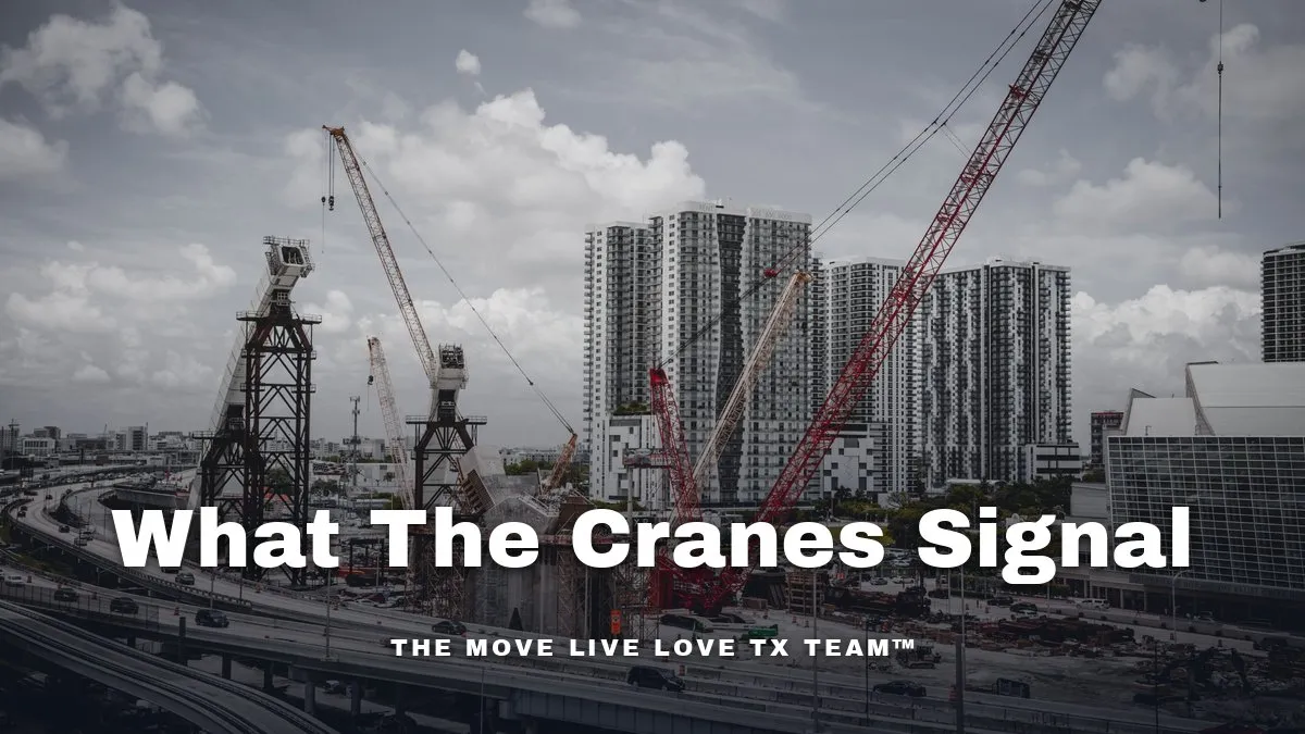 A construction crane rising over a commercial development site on a clear morning.