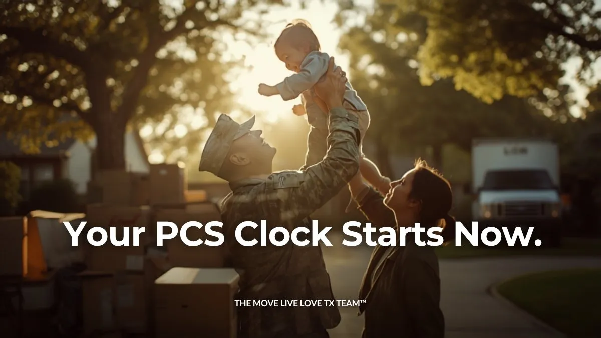 A service member in uniform lifting a young child into the air in a driveway with moving boxes and a moving truck, warm golden-hour light through trees