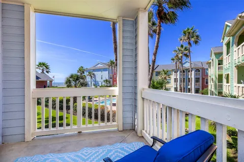 Palms, pool, and the Gulf of Mexico across Seawall Boulevard