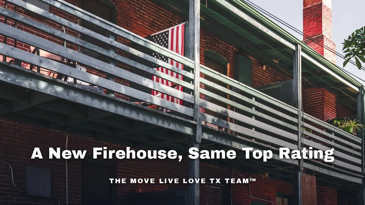 A modern brick fire station with an American flag flying on a flagpole under a bright blue Texas sky